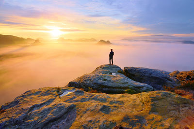 Sharp rear man silhouette on rocky peak. satisfy hiker enjoy view. autumnal  kleiner winterberg