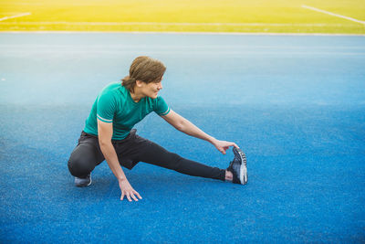 Young man exercising at stadium