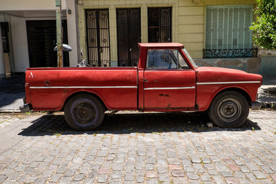 Vintage car parked on street against building