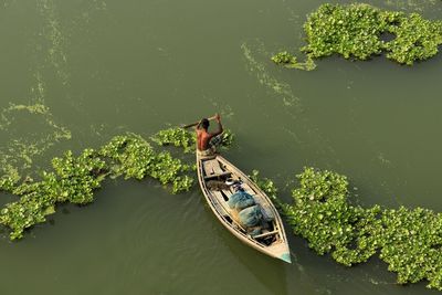 High angle view of man floating on lake