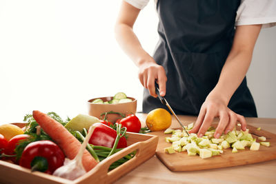 Midsection of man preparing food in kitchen at home