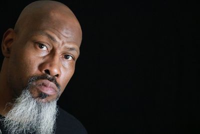 Portrait of man against black background