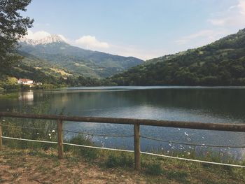 Scenic view of lake and mountains against sky