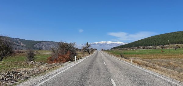 Road amidst landscape against sky