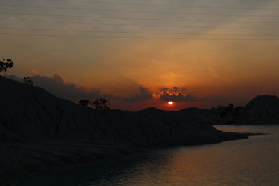 Scenic view of silhouette mountains against sky during sunset