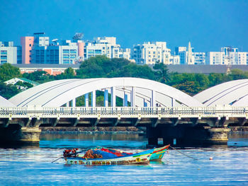 Bridge over river with buildings in background