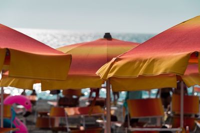 Beach umbrellas against clear sky