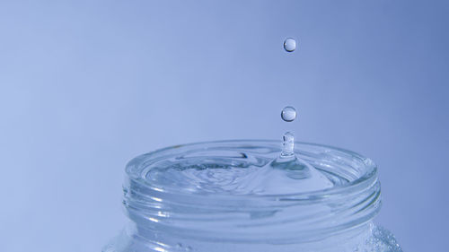 Close-up of water dropping in glass jar