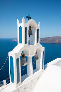 Bell tower against seascape