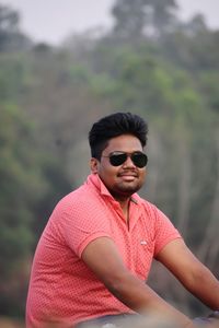 Young man wearing sunglasses standing outdoors