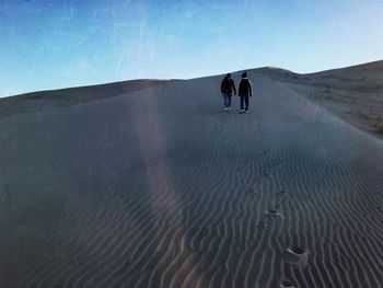 Full length of people on mountain landscape