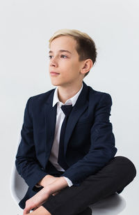 Portrait of businessman standing against white background