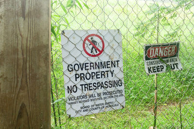 Information sign on plant by fence