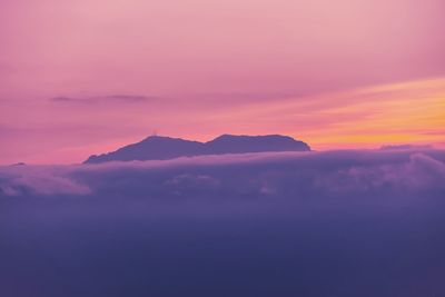 Scenic view of mountains against romantic sky at sunset
