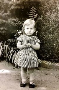 Portrait of cute girl standing outdoors