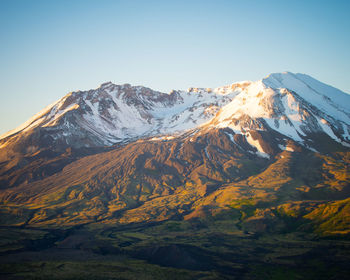 Scenic view of snowcapped mountains against clear sky