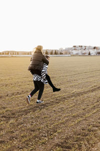 Couple piggyback and running in the countryside embraced. boyfriend and girlfriend in love