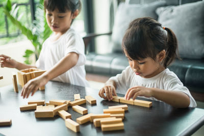 Boy playing with toy on table