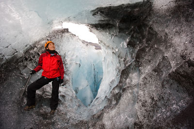 Woman exploring ice cave on sólheimajökull glacier in south iceland