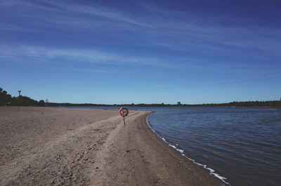 Scenic view of beach against blue sky