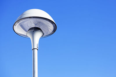 New street lamp against blue summer sky