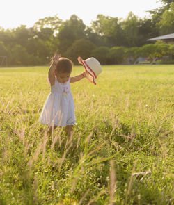  asian baby girl walking in the meadow with copy space happy family day concept. silhouette.