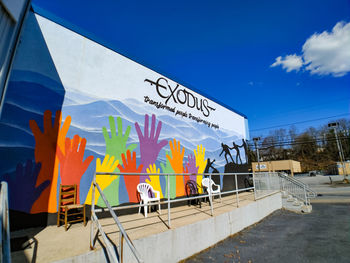 Graffiti on wall against blue sky