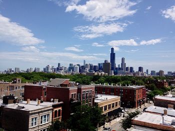 Cityscape against cloudy sky