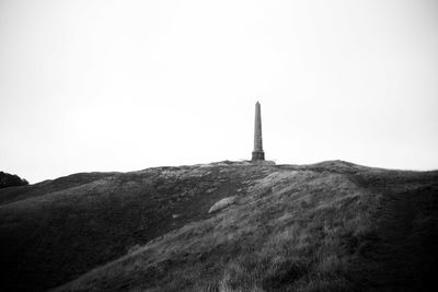 View of tower on mountain against sky