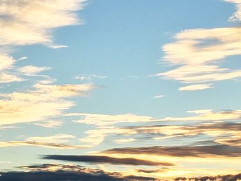 Low angle view of clouds over mountain against sky