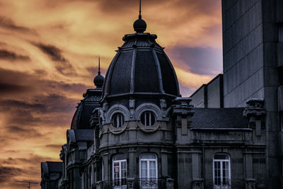 Low angle view of building against sky during sunset