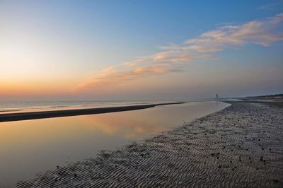 Scenic view of sea against sky at sunset