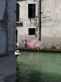 Reflection of man on window of abandoned building