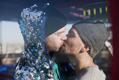 Full length portrait of young couple kissing