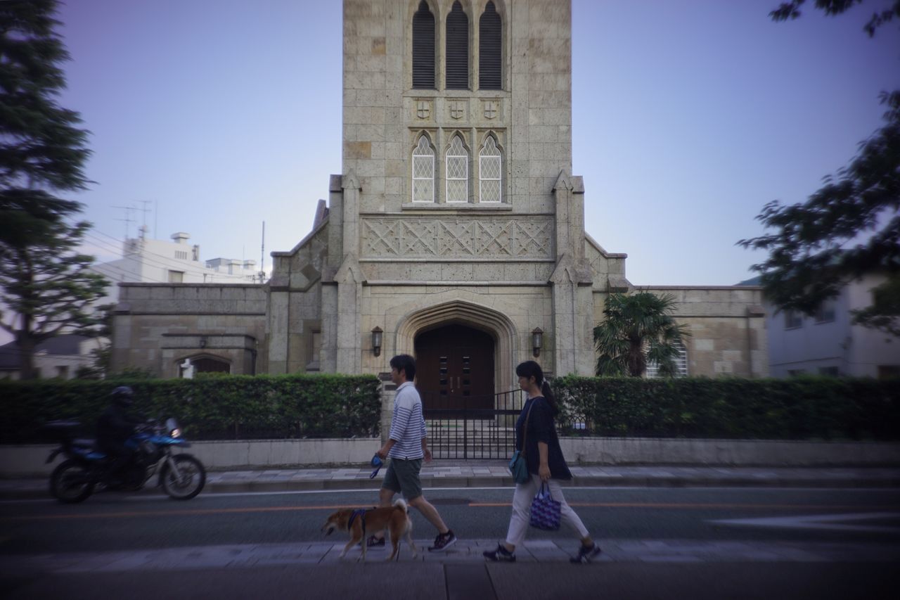 TOURISTS WALKING IN CITY