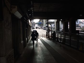 Rear view of silhouette man walking in city