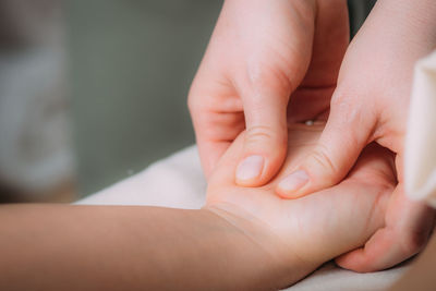 Hand massage in a massage salon, woman having a relaxing hand massage.
