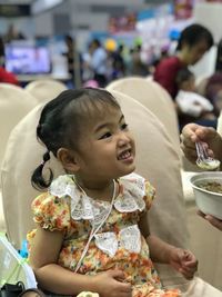 Innocent girl sitting on chair