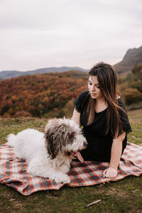 Young woman with dog on mountain