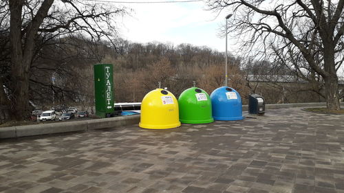 Multi colored balloons on garbage against sky