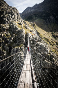 Rear view of people on footbridge