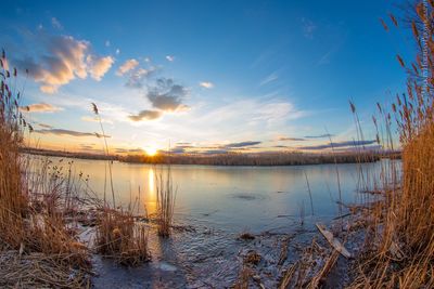 Scenic view of lake at sunset