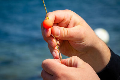 Close-up of hand holding fishing line