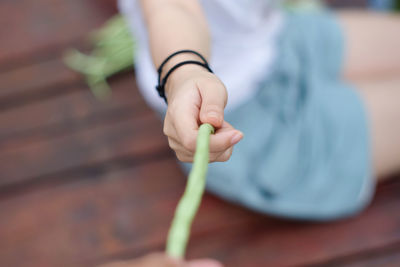 Close-up of woman holding hands on table