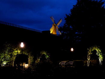 Traditional windmill against sky at night