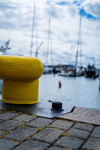 Close-up of yellow sailboats on footpath in city