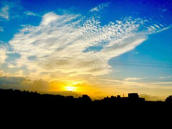 Silhouette landscape against sky during sunset