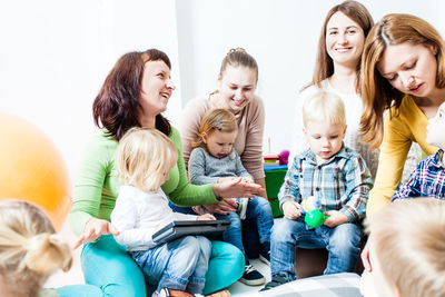 Cheerful mothers with kids