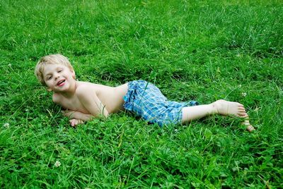 Portrait of smiling boy on grassy field