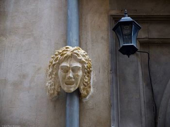 Low angle view of statue against building wall